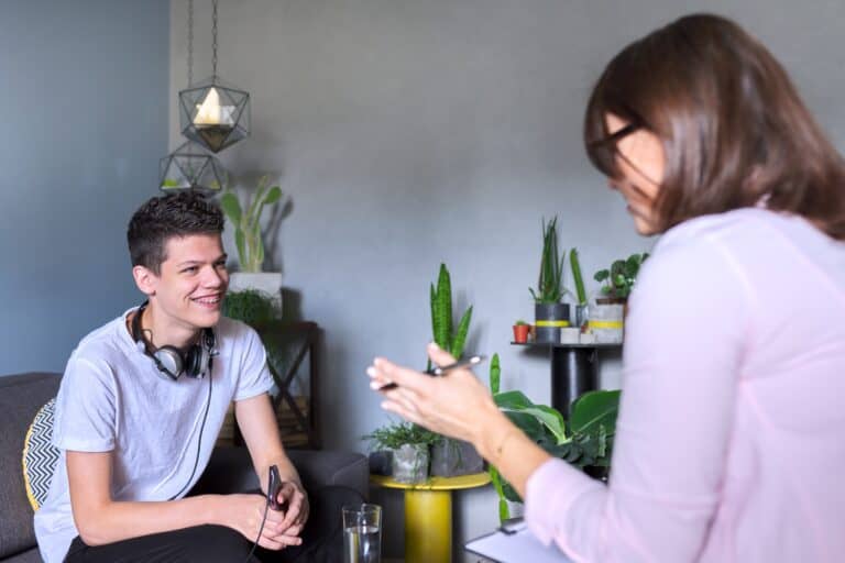 A teen male in face-to-face counselling