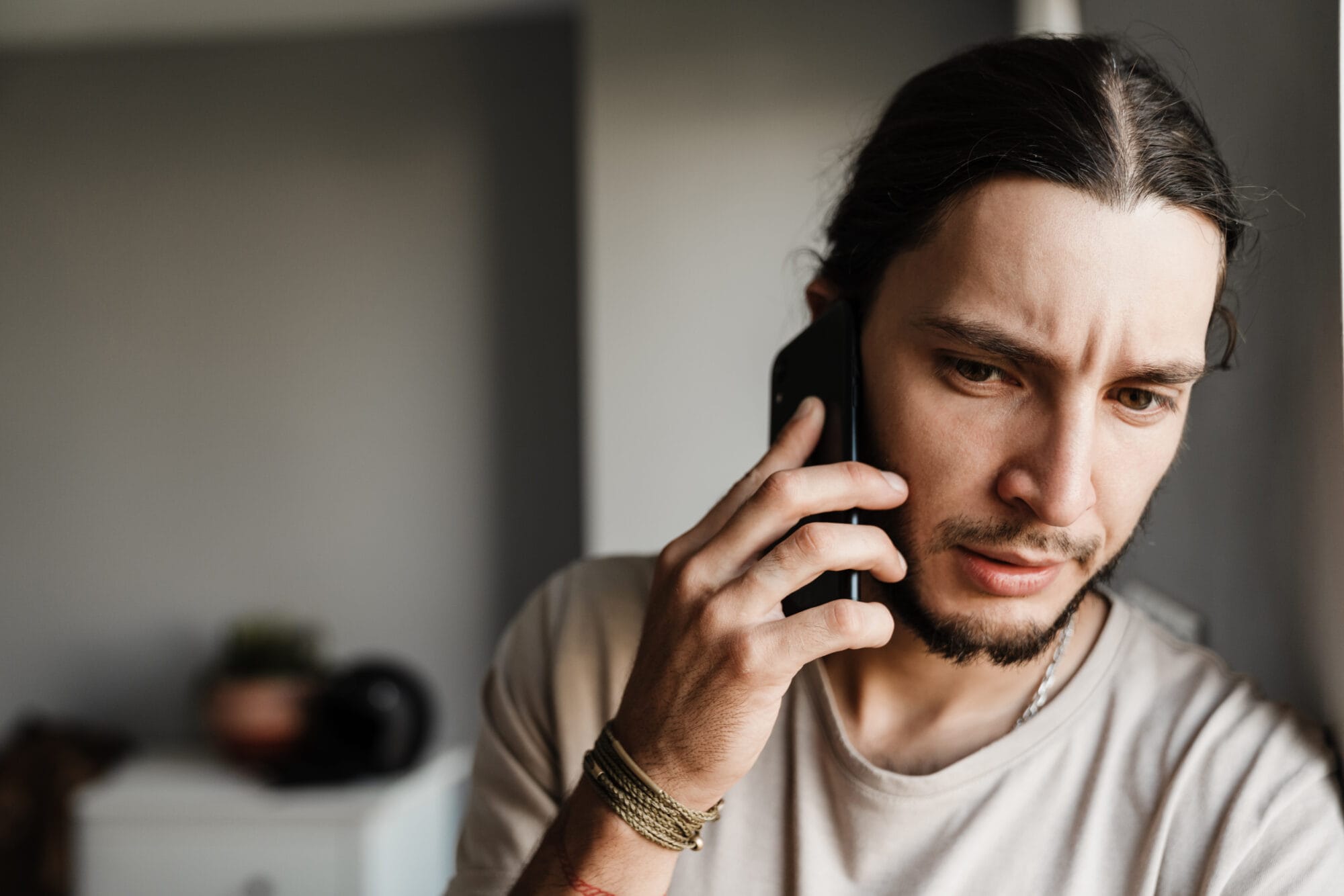 Man on the phone with a concerned expression