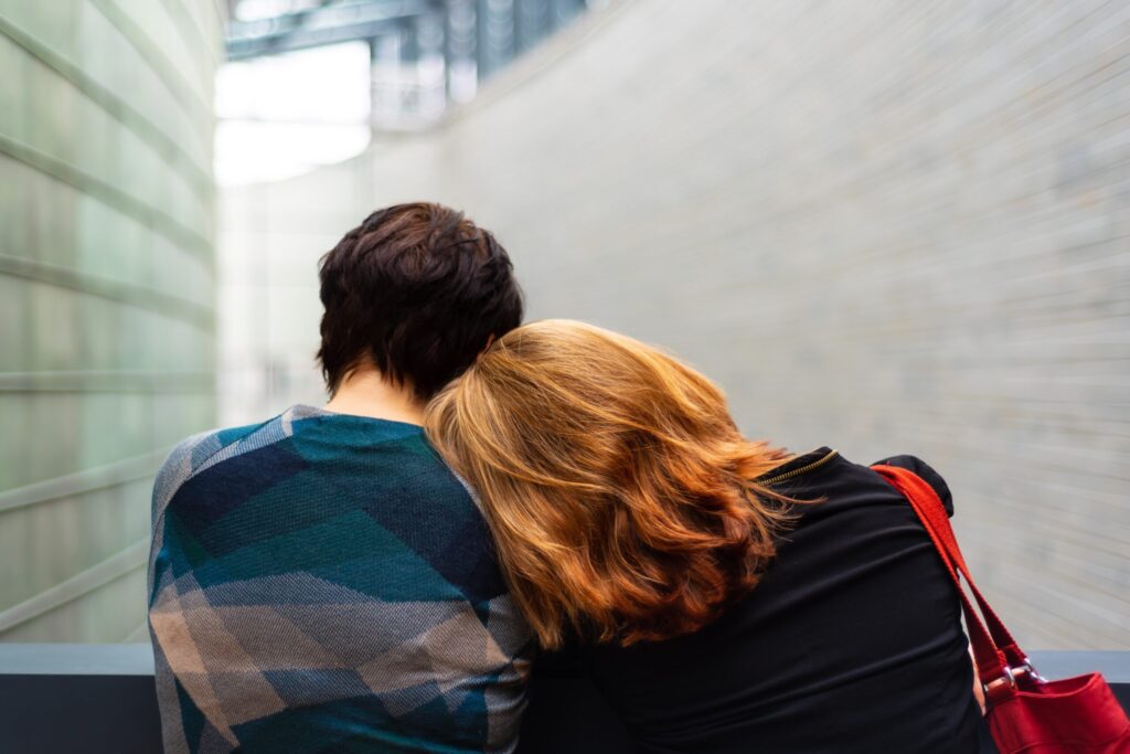 Couple resting their heads on each other